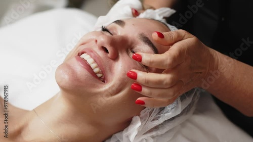 Wallpaper Mural Close-up of a young woman receiving a soothing facial massage at a beauty spa. The scene highlights the luxurious spa experience and emphasizes the benefits of professional skin and body care. Torontodigital.ca
