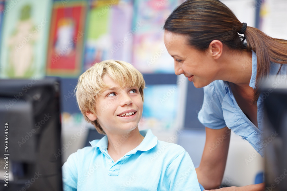 Woman, educator and smile with boy on computer in classroom for help, teaching and learning. People, teacher and happy with student at elementary school for education, support and brain development Woman, educator and smile with boy on computer in classroom for help, teaching and learning. People, teacher and happy with student at elementary school for education, support and brain development