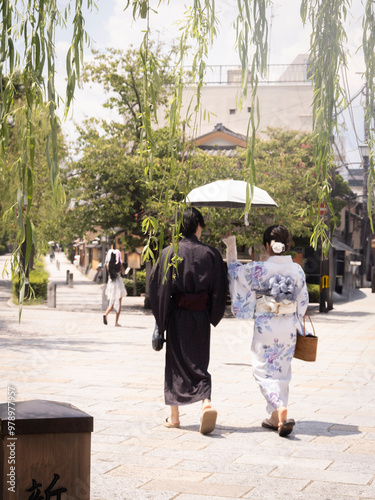 people with a kimono walking in the city