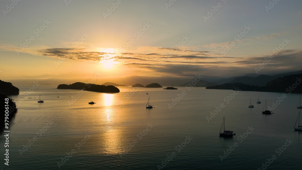 Aerial view of tranquil sunset over the ocean with silhouette of boats and islands, Paraty, Brazil. Aerial view of tranquil sunset over the ocean with silhouette of boats and islands, Paraty, Brazil.