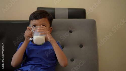 4k video of an Asian child drinking milk. health concept