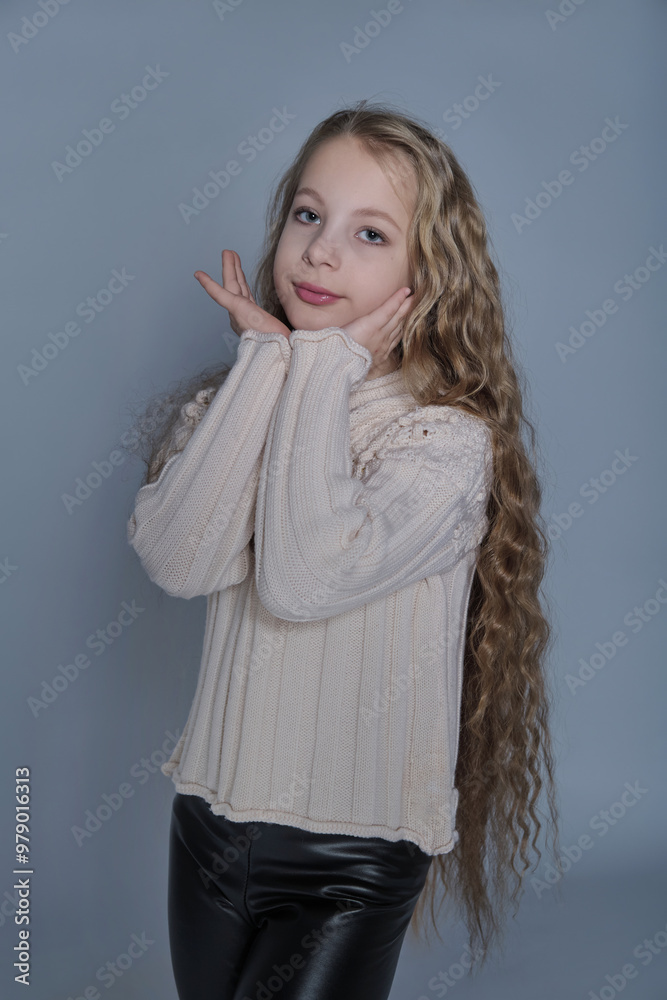 A girl with soft, wavy hair strikes a delicate pose, wearing a warm sweater, emphasizing both comfort and beauty. The photo captures the essence of childhood innocence while promoting natural hair A girl with soft, wavy hair strikes a delicate pose, wearing a warm sweater, emphasizing both comfort and beauty. The photo captures the essence of childhood innocence while promoting natural hair