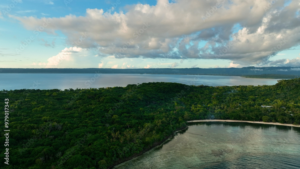 Aerial view of a beautiful tropical island at sunset with serene ocean and clouds, Port Vila, Vanuatu. Aerial view of a beautiful tropical island at sunset with serene ocean and clouds, Port Vila, Vanuatu.