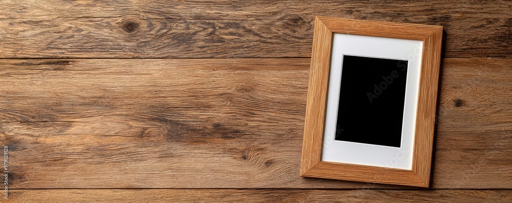 Empty photo frame on a rustic wooden table, perfect for showcasing cherished memories or artistic displays. Empty photo frame on a rustic wooden table, perfect for showcasing cherished memories or artistic displays.