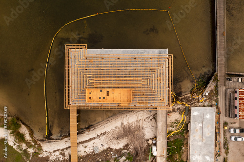 Aerial view of a construction site adjacent to Squid Lips restaurant with water and platforms, Sebastian, Florida. photo