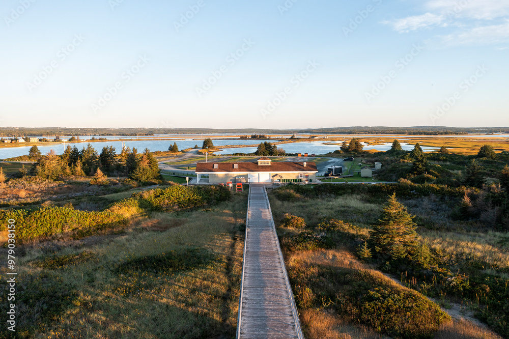 Aerial view of cow bay beach with serene water, trees, and a picturesque sunset, Cow Bay, Canada. Aerial view of cow bay beach with serene water, trees, and a picturesque sunset, Cow Bay, Canada.