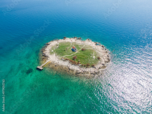 Aerial view of a beautiful turquoise island surrounded by clear blue sea, Novi Vinodolski, Croatia. photo