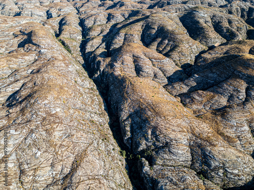 Aerial view of majestic and rugged mountains and valleys with a beautiful landscape, Morondava, Madagascar. Aerial view of majestic and rugged mountains and valleys with a beautiful landscape, Morondava, Madagascar.