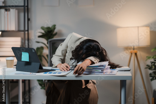 Tableau sur toile The Weight of Overwork: Exhausted businesswoman slumped over her desk, overwhelmed by paperwork and the demands of corporate life