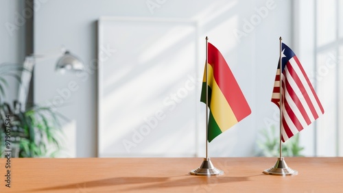 FLAGS OF BOLIVIA AND LIBERIA ON TABLE photo