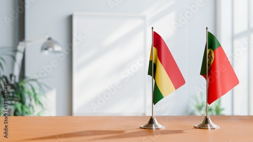 FLAGS OF BOLIVIA AND PORTUGAL ON TABLE