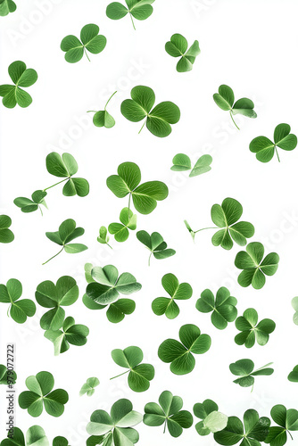 A swirl of four leaf clovers dancing gracefully in the air against a bright white background