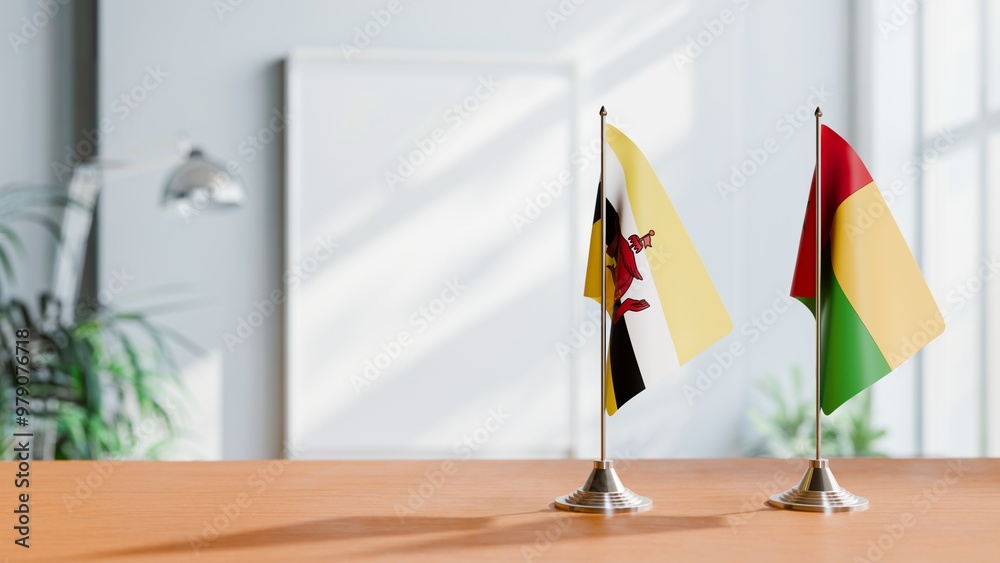 FLAGS OF BRUNEI AND GUINEA-BISSAU ON TABLE FLAGS OF BRUNEI AND GUINEA-BISSAU ON TABLE