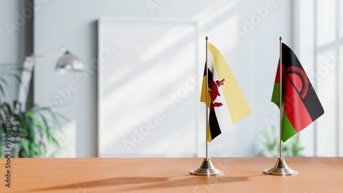 FLAGS OF BRUNEI AND MALAWI ON TABLE