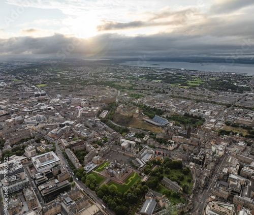 Aerial view of edinburgh castle amidst a vibrant cityscape with sprawling buildings and cloudy sky, southside, edinburgh, scotland. photo