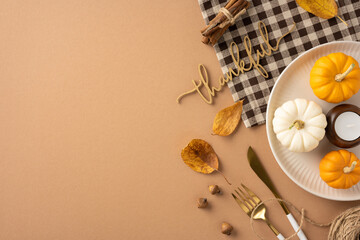 Autumn themed Thanksgiving table setting with small decorative pumpkins in warm colors, acorns, and a thankful sign on a plaid cloth background