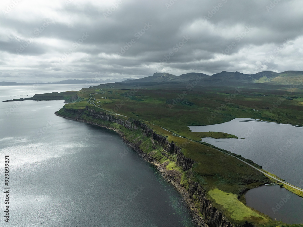 Aerial view of rugged cliffs and tranquil waters of the North Sea, Portree, Scotland. Aerial view of rugged cliffs and tranquil waters of the North Sea, Portree, Scotland.