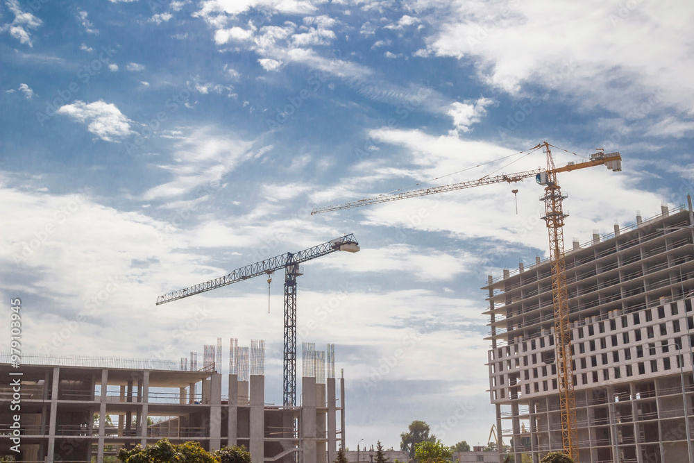 Fototapeta premium Unfinished construction. Two buildings and two tower cranes.