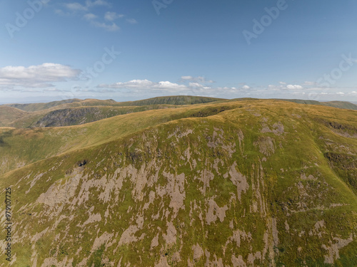 Aerial view of scenic Kirkstone Pass with hills and valleys under a cloudy sky, Penrith, United Kingdom. photo