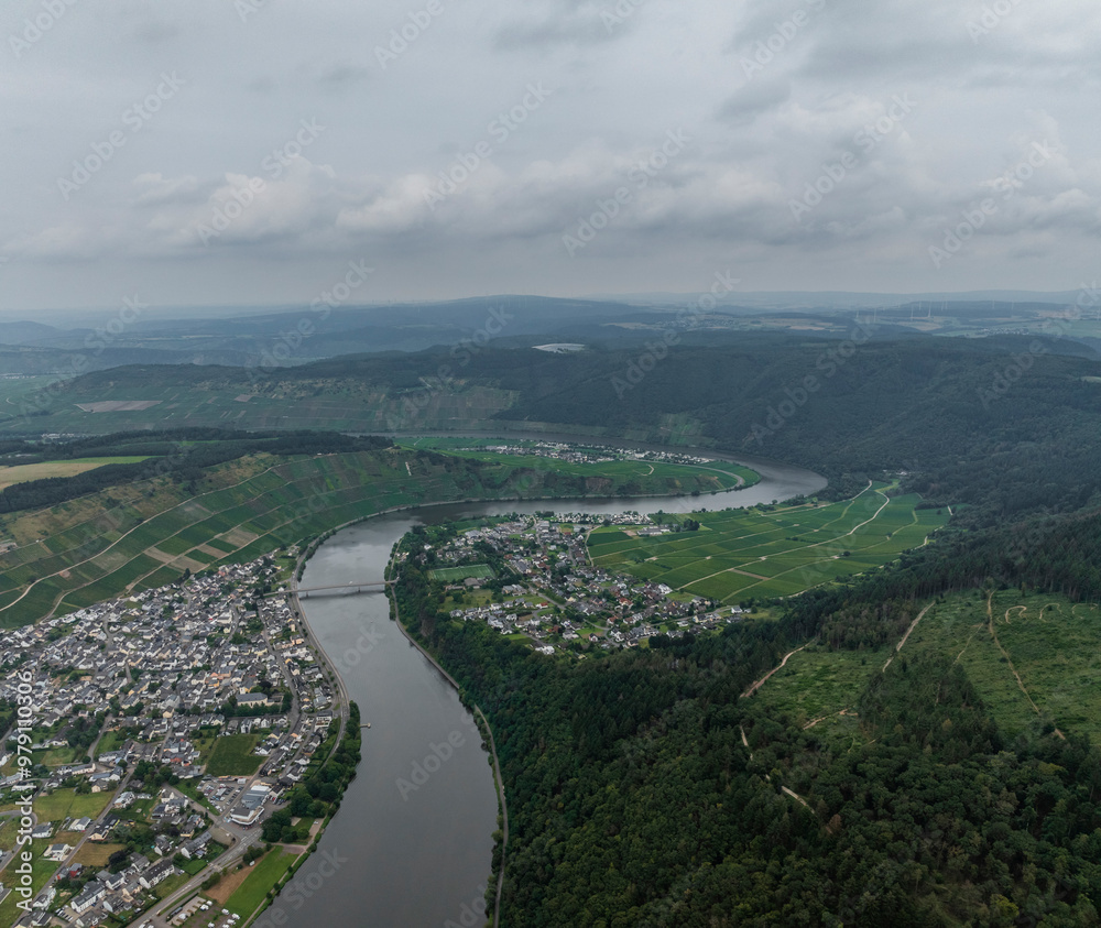 Aerial view of the scenic Moselle River winding through lush vineyards and tranquil hills, Mehring, Germany. Aerial view of the scenic Moselle River winding through lush vineyards and tranquil hills, Mehring, Germany.