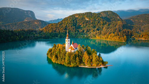Aerial drone view of Lake Bled with famous church on the island during sunrise, Slovenia