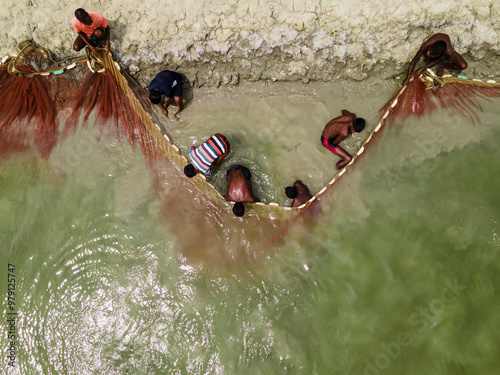 Khulna, Bangladesh - 14 May 2023: Aerial view of coastal village with fishermen working in mangrove forest and fishing nets, Khulna, Bangladesh. photo