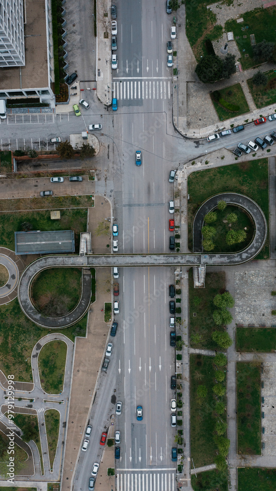 Aerial view of a modern urban intersection with cars and buildings surrounded by greenery, Thessaloniki, Greece. Aerial view of a modern urban intersection with cars and buildings surrounded by greenery, Thessaloniki, Greece.