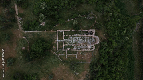 Aerial view of the ancient Basilica of Saint Achillius amidst beautiful greenery and ruins, Agios Achillios, Greece. photo