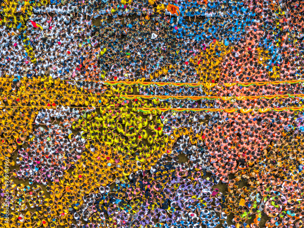 Aerial view of vibrant dahi handi festival with a colorful crowd and human towers, Thane, India. Aerial view of vibrant dahi handi festival with a colorful crowd and human towers, Thane, India.