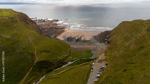 Aerial view of duckpool beach with rugged cliffs and tranquil ocean, Bude, England. photo