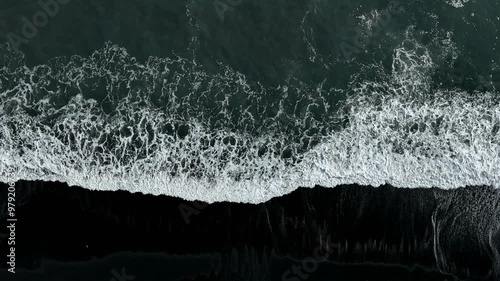 Sea waves breaking on the shore of a black sand beach on Iceland