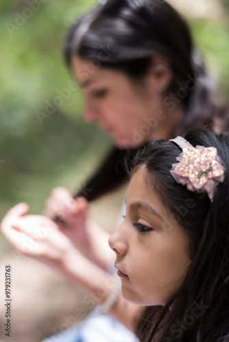 Little girl portrait and mother in background photo