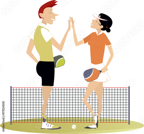 Man and woman play pickleball.
Pickleball court. Man and woman congratulate one another with a good shot
