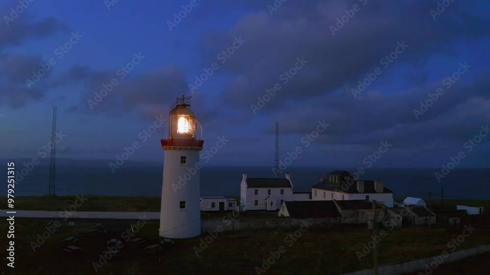 Aerial pan of lighthouse beacon shining just before sunrise. Loop Head. Co Clare Aerial pan of lighthouse beacon shining just before sunrise. Loop Head. Co Clare