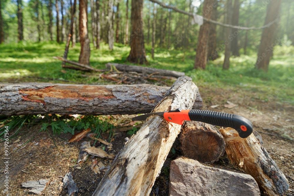 Naklejka premium hand saw on wild camping