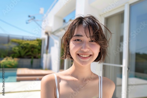 Free Download Poolside in a white bikini, a young Asian woman’s radiant smile and carefree demeanor capture the essence of summer relaxation and luxury, enhanced by the vibrant pool setting. - GFXLoad