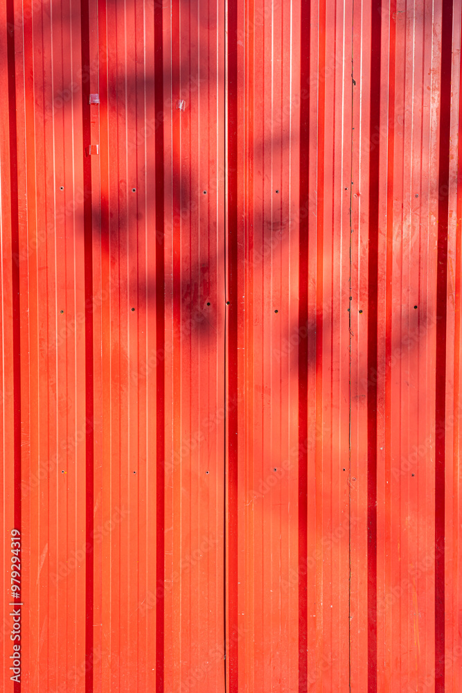 Red or orange old corrugated metal with Shadow of a branch texture surface sheet for industrial building background, copy space text or design Red or orange old corrugated metal with Shadow of a branch texture surface sheet for industrial building background, copy space text or design