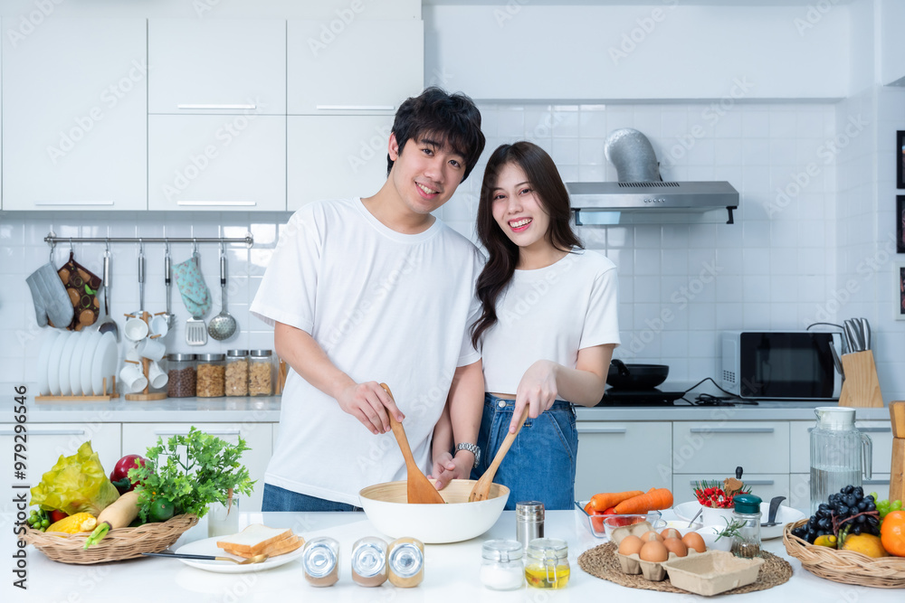 Happy Family portrait of loving young asian of having fun standing a cheerful preparing food and enjoy cook cooking with vegetables, meat, bread while standing on a kitchen Condo life or home