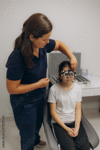 Optometrist examines the sight of young girl photo