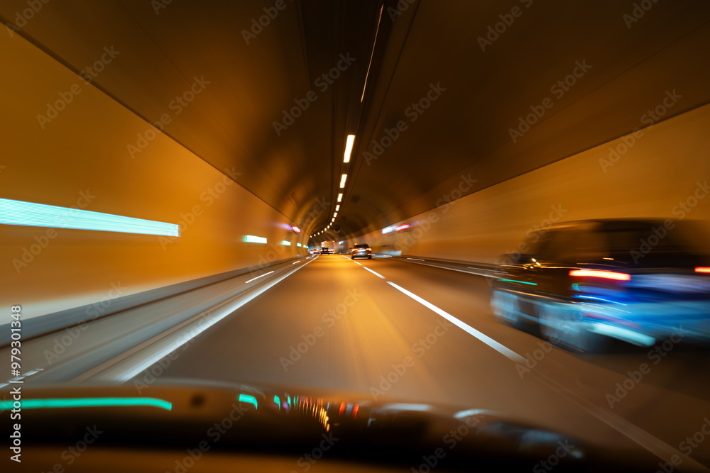 Blurred cars in an illuminated underground tunnel. Slow shutter speed, cars in traffic, no people Blurred cars in an illuminated underground tunnel. Slow shutter speed, cars in traffic, no people