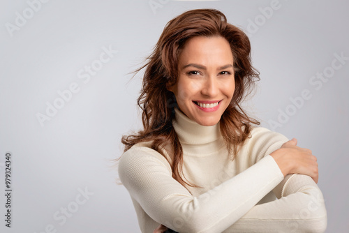 Obraz na płótnie Studio portrait of mid aged woman cheerful smling against isolated background