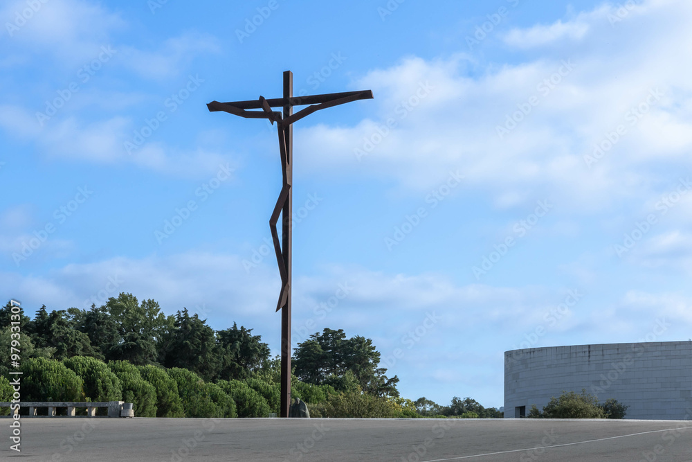 Cross Jesus Christ crucified stylized outline in steel on the square in Fatima Portugal Cross Jesus Christ crucified stylized outline in steel on the square in Fatima Portugal