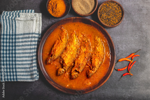 A rich, spicy Bengali dish featuring soft pabda fish simmered in a flavorful mustard-tomato gravy. photo