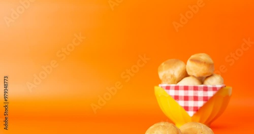 Minas Gerais cheese bread, hot, ina  wooden basket in clean brown background