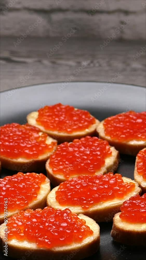 Appetizing Red Caviar Canapés On Black Plate For Elegant Dining. Vertical. Appetizing Red Caviar Canapés On Black Plate For Elegant Dining. Vertical.