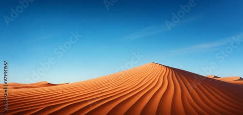 A vast desert landscape featuring stunning orange sand dunes and a clear blue sky, perfect for nature and travel themes.