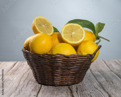 lemons in a basket, with one cut showing its interior