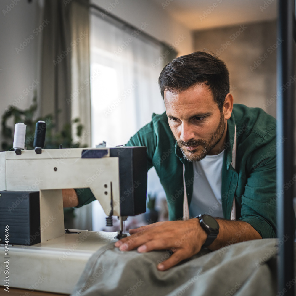 Adult man tailor, designer work at sewing machine in cozy home setting Adult man tailor, designer work at sewing machine in cozy home setting