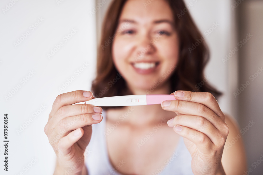 Hands, pregnancy test and positive results for woman with smile, portrait and excited with blur in home. Person, mother and lines on stick for fertility, conception and happy for baby at apartment Hands, pregnancy test and positive results for woman with smile, portrait and excited with blur in home. Person, mother and lines on stick for fertility, conception and happy for baby at apartment