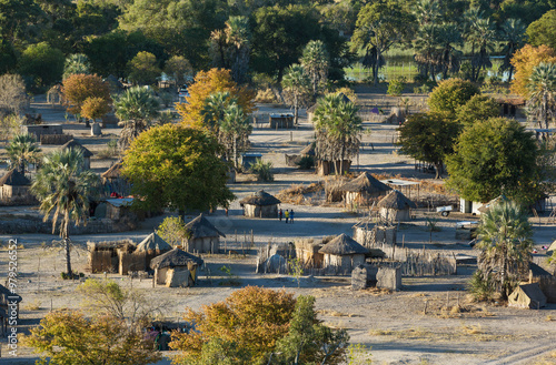 Aerial view of Native village just outside of the protected area, prominent a group of young men getting ready for a football match, aerial view, Okavango Delta, Botswana.
